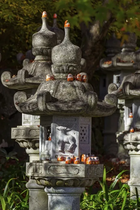Framed Print : Stone lanterns with small figures in a Japanese garden