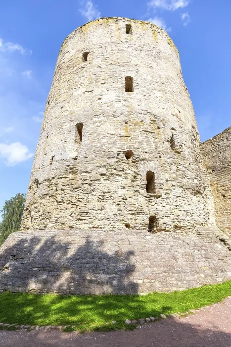 Framed Print : Stone tower of the ancient Izborsk fortress against a blue sky in summer