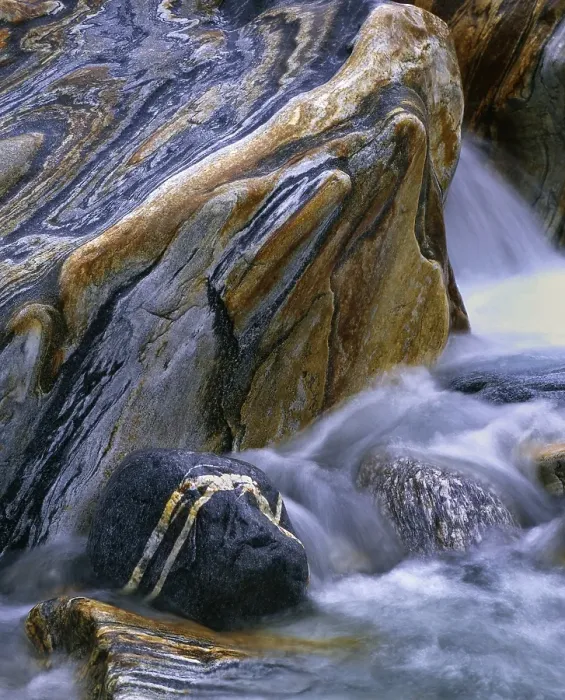 Framed Print : Stones with rock veins and running water