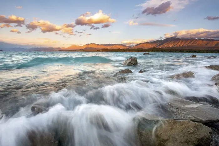 Framed Print : Stones on shore, lake with sunset swell
