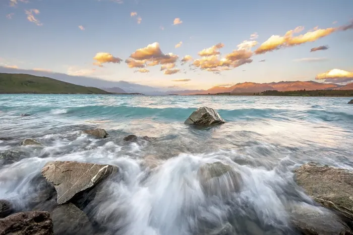 Framed Print : Stones on shore, lake with sunset swell