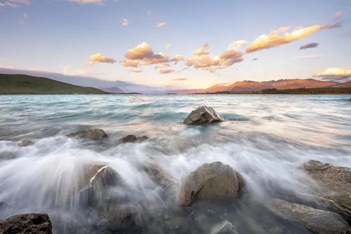 Framed Print : Stones on shore, lake with sunset swell
