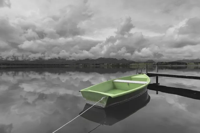 Framed Print : Storm clouds at sunset, a green rowing boat lashed to the wooden jetty