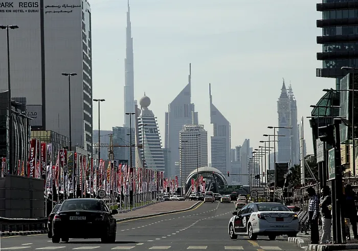 Framed Print : Street with car traffic, flagpoles