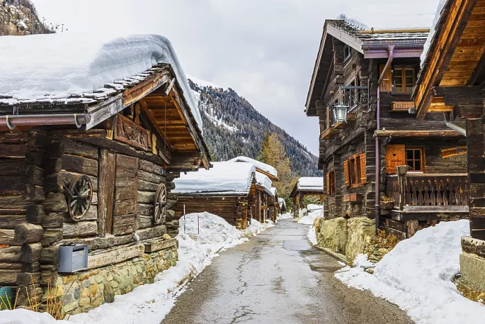 Framed Print : Street with historic old snow-covered wooden houses