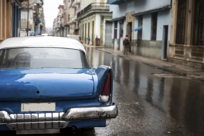 Framed Print : Street scene with old car on rainy day in Havana