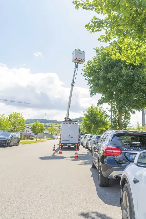 Framed Print : Street scene with a vehicle and raised aerial work platform