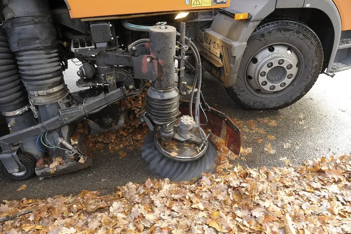 Framed Print : Street sweeper removing leaves in a city