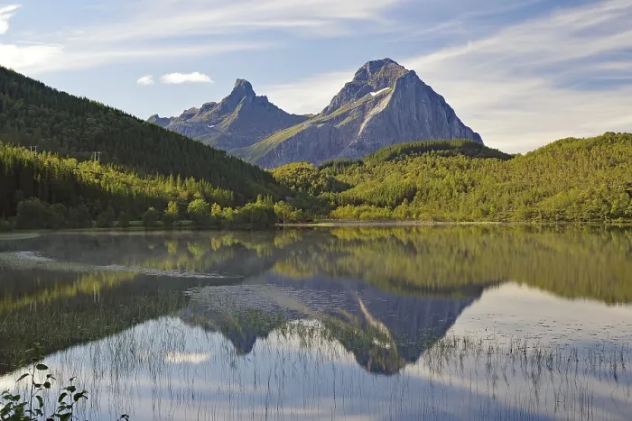 Framed Print : Striking mountains reflected in the calm waters of a small lake