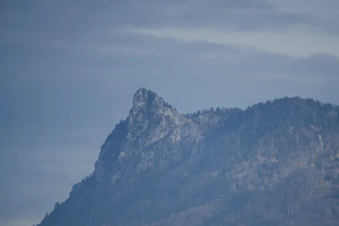 Framed Print : A striking wooded mountain with rock formation against the sky