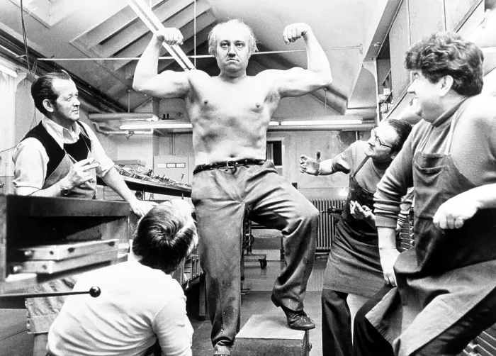 Framed Print : Strong man poses and shows his muscles