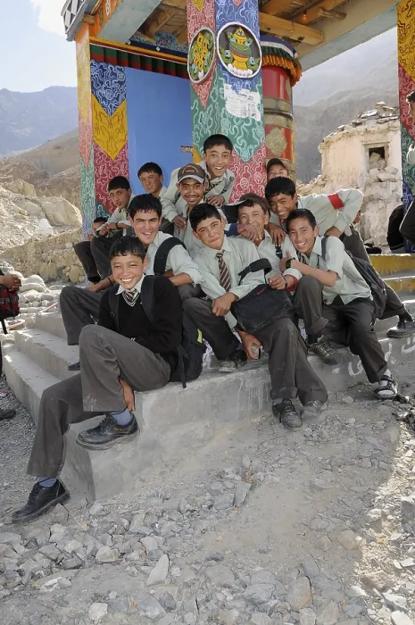 Framed Print : Students wearing uniforms in front of a prayer wheel in Hunder Framed Print : Students wearing uniforms in front of a prayer wheel in Hunder
