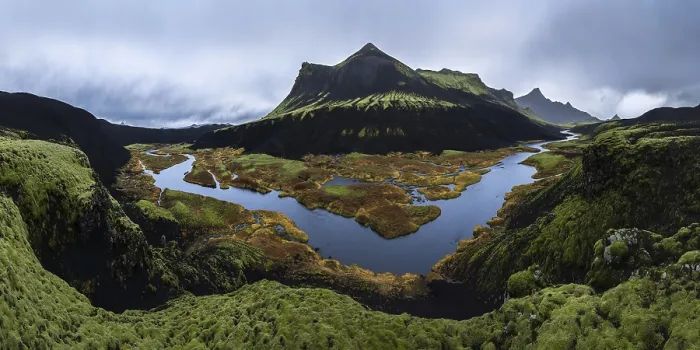 Framed Print : A stunning panoramic view of a moss-covered volcanic mountain with a winding river Framed Print : A stunning panoramic view of a moss-covered volcanic mountain with a winding river
