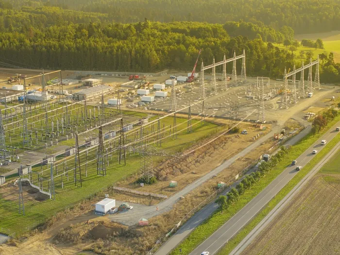 Framed Print : Substation under construction, surrounded by green fields and forests