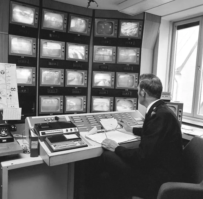 Framed Print : Subway safety in the 1970s. The feed from the subway surveillance cameras are monitored. A man in the control room have many different monitors in front of him and his job is to alert security, police or ambulance if he see something happening