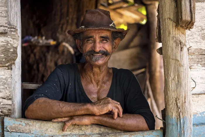 Framed Print : Sugar cane farmer wearing a hat