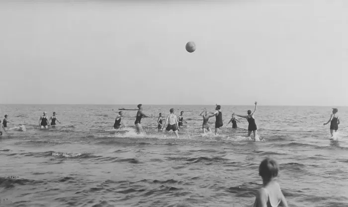 Framed Print : Summer in the 1920s. A group of people are playing ball in the water on a sunny day on the beach. Sweden 1920s