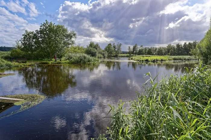 Framed Print : Sun and clouds over the River Trave in Brenner Moor