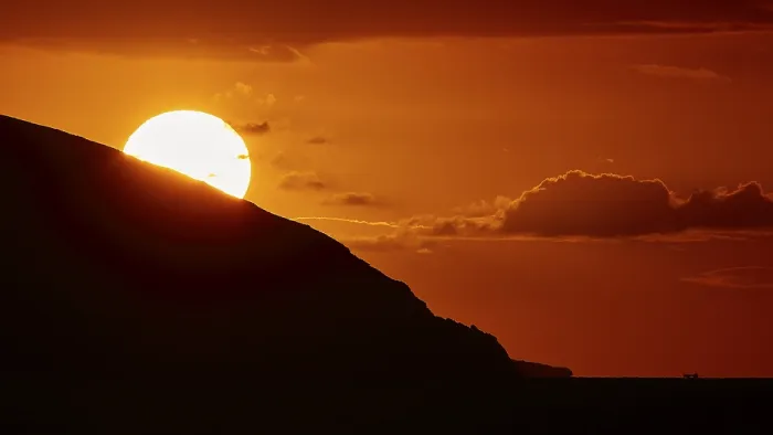 Framed Print : Sun disappears behind mountain