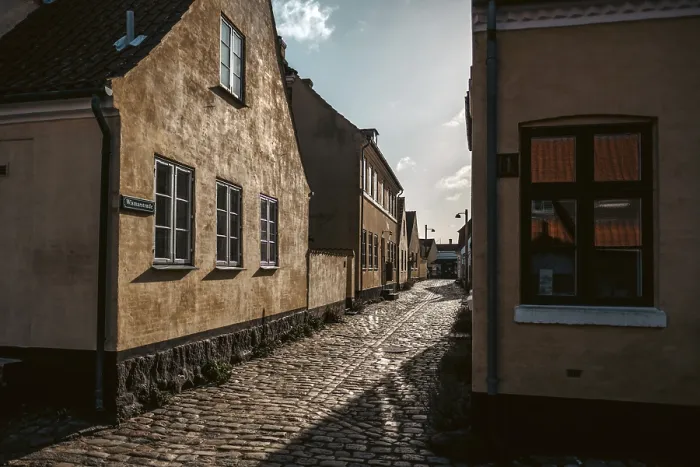 Framed Print : A sun drenched laneway in Danish fishing village of Dragor Framed Print : A sun drenched laneway in Danish fishing village of Dragor
