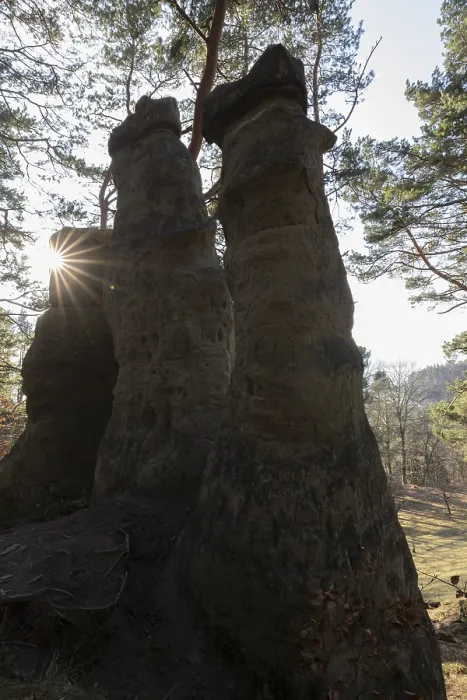 Framed Print : Sun rays appearing between two high rocks in the forest