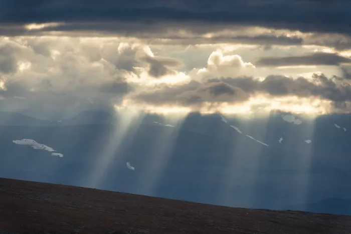 Framed Print : Sun rays fall through clouds in mountain landscape Framed Print : Sun rays fall through clouds in mountain landscape