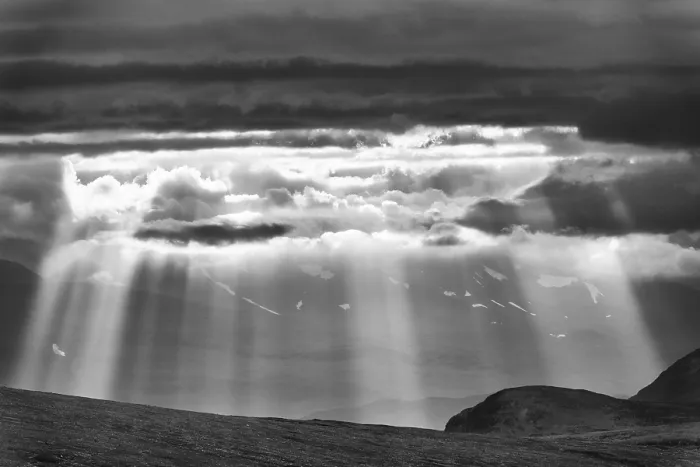 Framed Print : Sun rays fall through clouds in mountain landscape Framed Print : Sun rays fall through clouds in mountain landscape