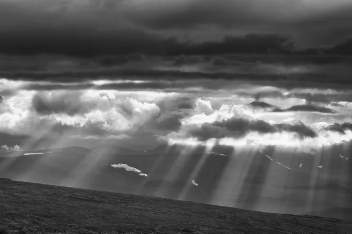 Framed Print : Sun rays fall through clouds in mountain landscape Framed Print : Sun rays fall through clouds in mountain landscape