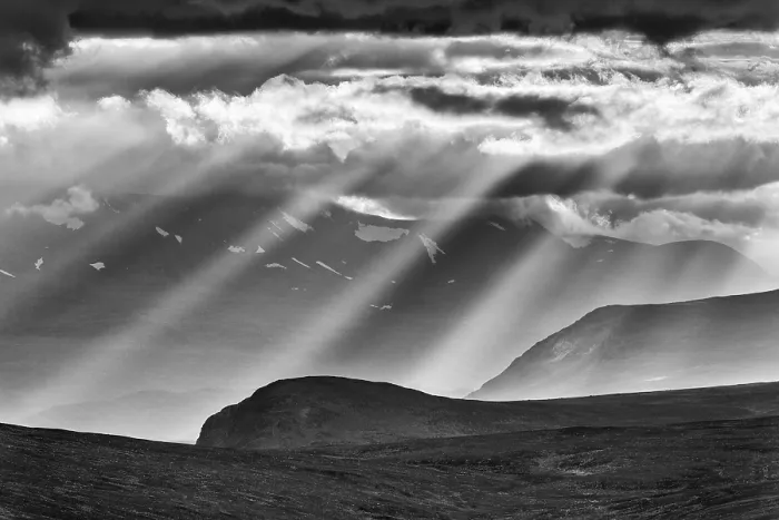 Framed Print : Sun rays fall through clouds in mountain landscape Framed Print : Sun rays fall through clouds in mountain landscape