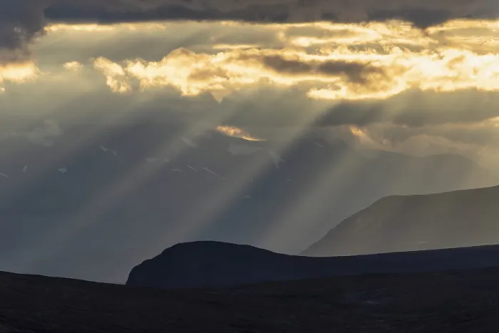 Framed Print : Sun rays fall through clouds in mountain landscape Framed Print : Sun rays fall through clouds in mountain landscape