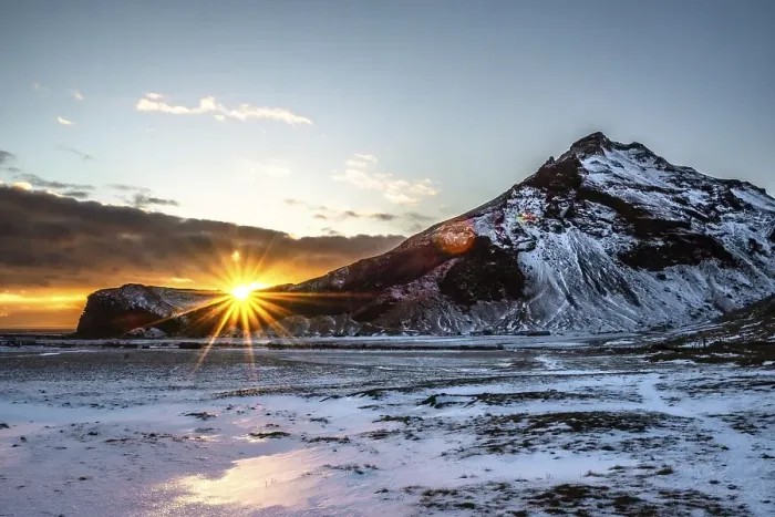 Framed Print : The sun rises behind snow-covered mountains and bathes the wintry landscape in warm light Framed Print : The sun rises behind snow-covered mountains and bathes the wintry landscape in warm light