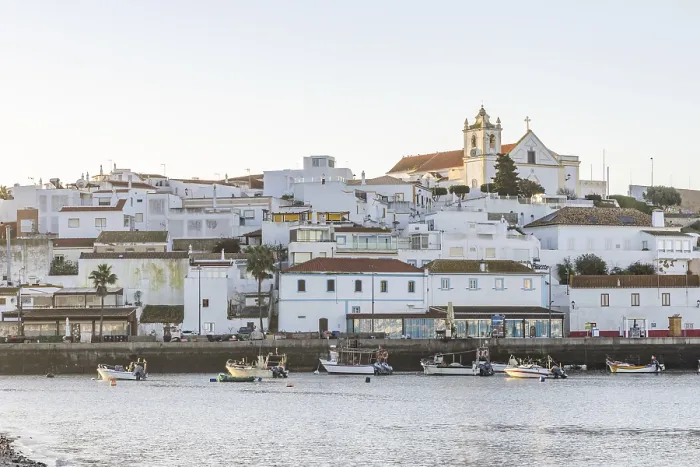 Framed Print : Sunrise on the Atlantic, skyline of a fishing village behind a harbour Framed Print : Sunrise on the Atlantic, skyline of a fishing village behind a harbour