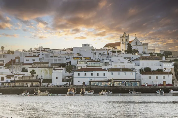 Framed Print : Sunrise on the Atlantic, skyline of a fishing village behind a harbour Framed Print : Sunrise on the Atlantic, skyline of a fishing village behind a harbour
