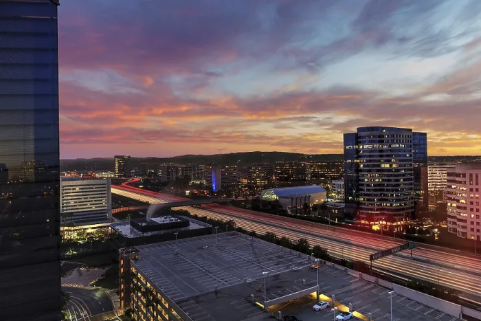 Framed Print : Sunrise over light trails and city lights on a highway in Irvine