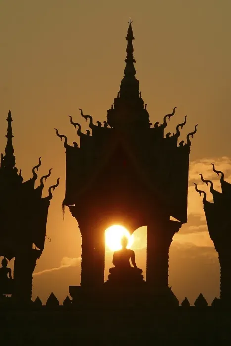 Framed Print : Sunset behind a Buddha statue at That Luang Vientiane Framed Print : Sunset behind a Buddha statue at That Luang Vientiane