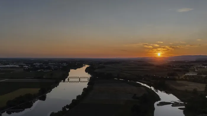 Framed Print : Sunset over a calm river with railway bridge and surrounding landscape