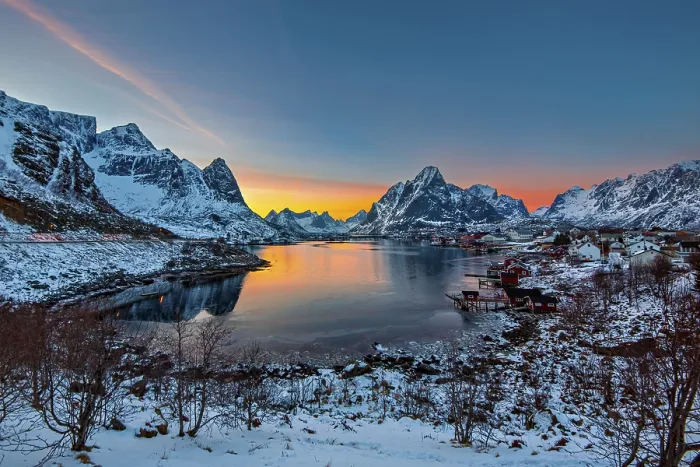 Framed Print : Sunset casting warm hues over a tranquil fjord surrounded by snow-covered mountains