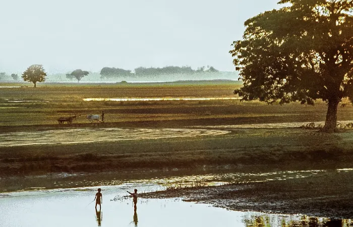 Framed Print : Sunset, fishing children and ploughing farmer at a lake