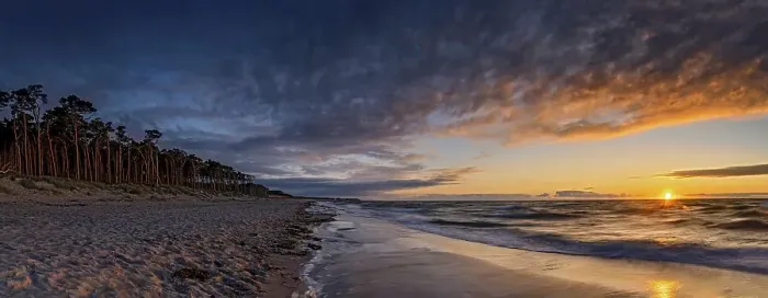 Framed Print : Sunset on the west beach near Prerow with illuminated trees as a long exposure