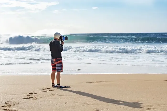 Framed Print : A surf photographer taking photographs by the shore at Banzai Pipeline