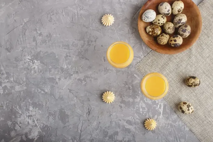Framed Print : Sweet egg liqueur in glass with quail eggs and meringues on a gray concrete background Framed Print : Sweet egg liqueur in glass with quail eggs and meringues on a gray concrete background