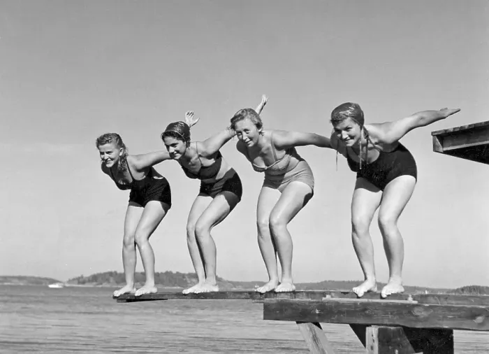 Framed Print : Swimming in the 1940s. A line of four women are standing ready to jump in the water on a summer's day Framed Print : Swimming in the 1940s. A line of four women are standing ready to jump in the water on a summer's day