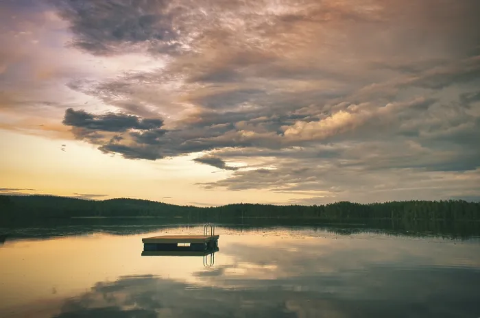 Framed Print : Swimming island in Sweden on a lake at sunset
