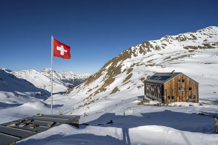 Framed Print : Swiss flag and mountain hut Keschhutte in front of mountain landscape in winter Framed Print : Swiss flag and mountain hut Keschhutte in front of mountain landscape in winter