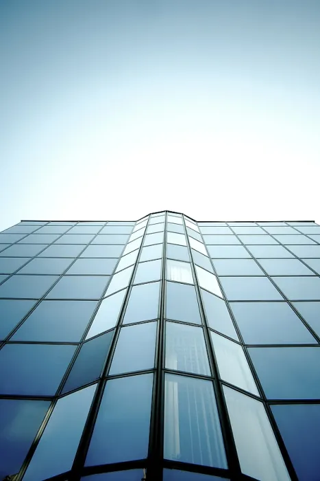 Framed Print : Symmetrical glass building with reflective surface and blue sky Framed Print : Symmetrical glass building with reflective surface and blue sky