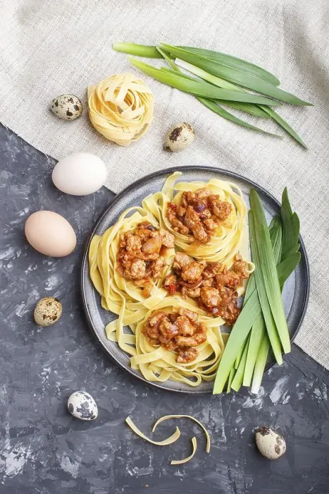 Framed Print : Tagliatelle bolognese pasta with minced meat on a black concrete background