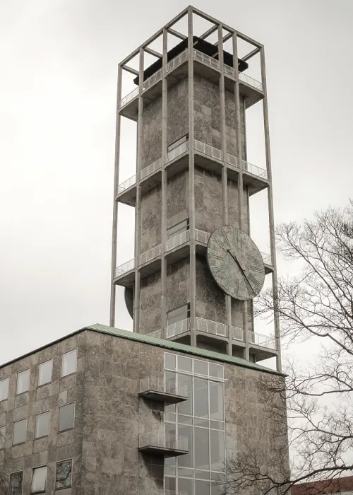Framed Print : Tall concrete clock tower with minimalistic design against a cloudy sky in Aarhus