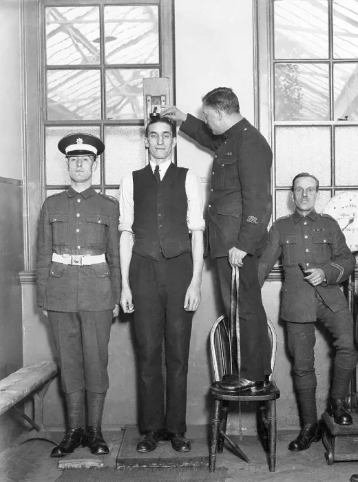 Framed Print : Tall man being measured, army physical Framed Print : Tall man being measured, army physical