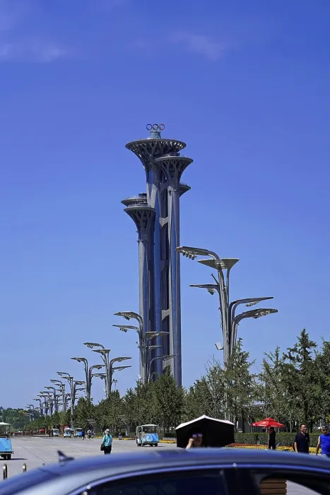 Framed Print : Tall Olympic tower in modern architecture surrounded by trees and clear sky