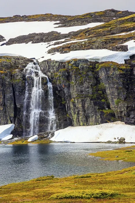Framed Print : Tall waterfall falls into the lake